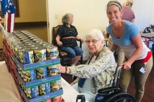 Pre-COVID resident and employee participating in "Independence from Hunger" campaign